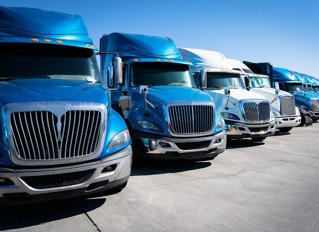 Blog - Fleet of Blue and White Trucks at a Parking Lot on a Sunny Day